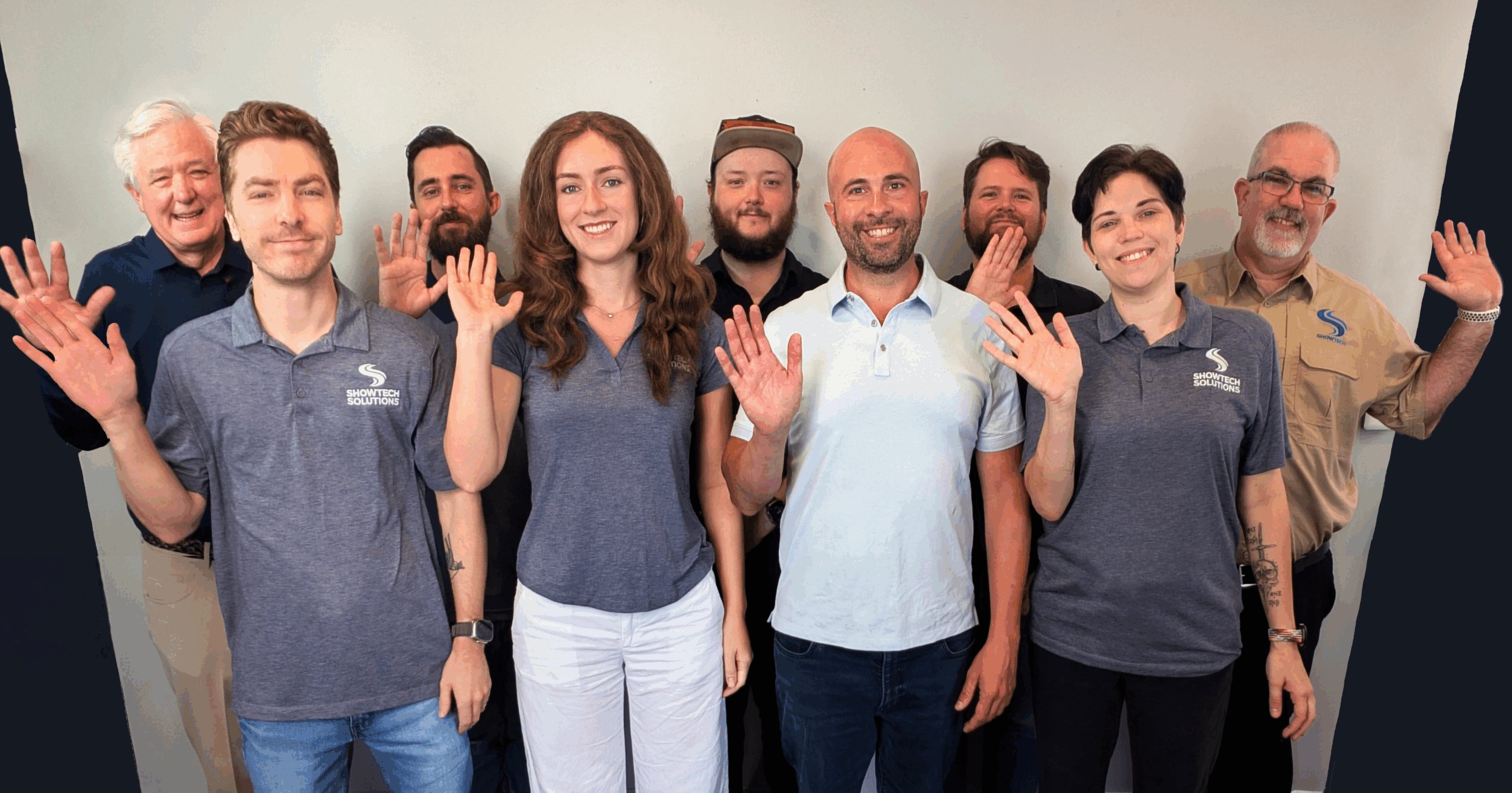 Group photo of the employees of ShowTech. Everyone is waving