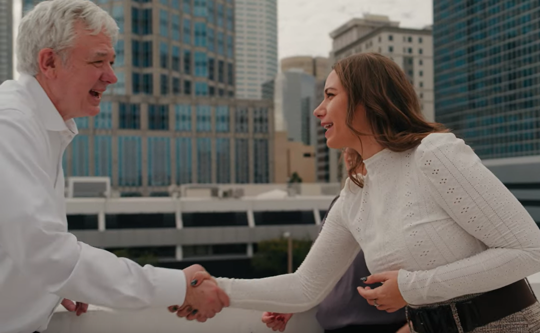 Cary and a woman shaking hands
